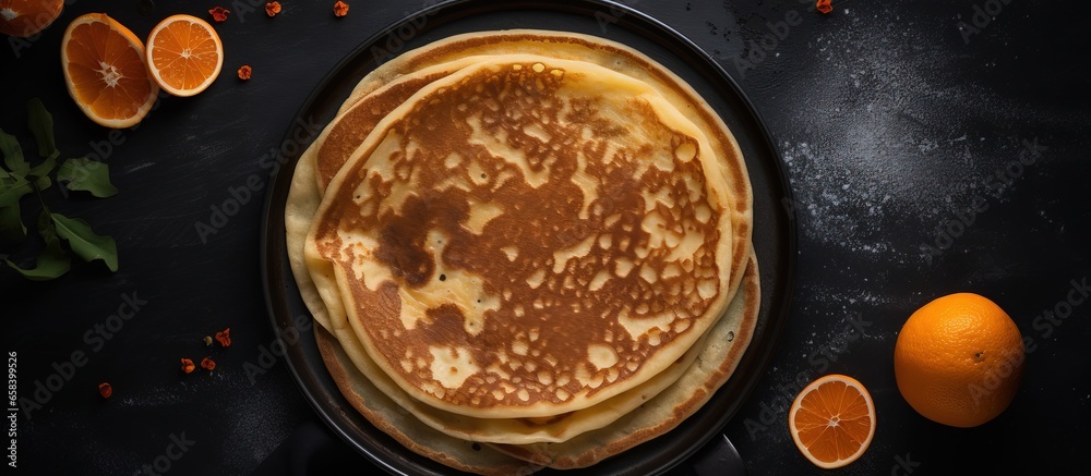 Cooking process of making thin pancakes crepes russian blini step by step frying on black skillet Maslenitsa concept top view ingredients grey background