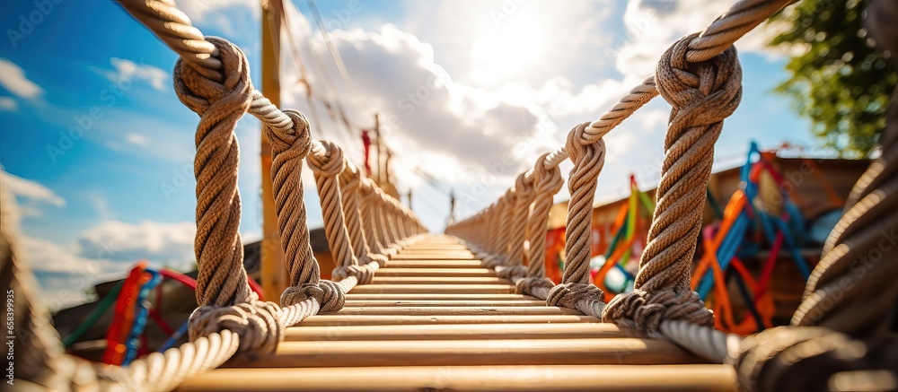 Bottom view photo of a high quality rope ladder at a summer amusement park for climbing