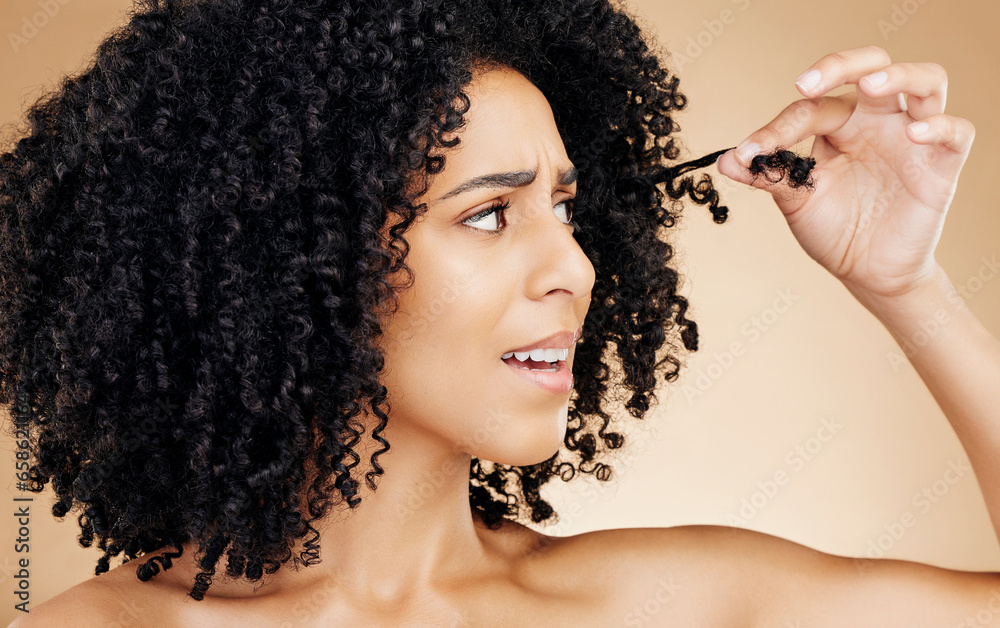 Hair care, afro and face of woman with problem, anxiety or worried about grooming mistake, beauty salon treatment or damage. Haircut disaster, broken dry strand and model stress on brown background