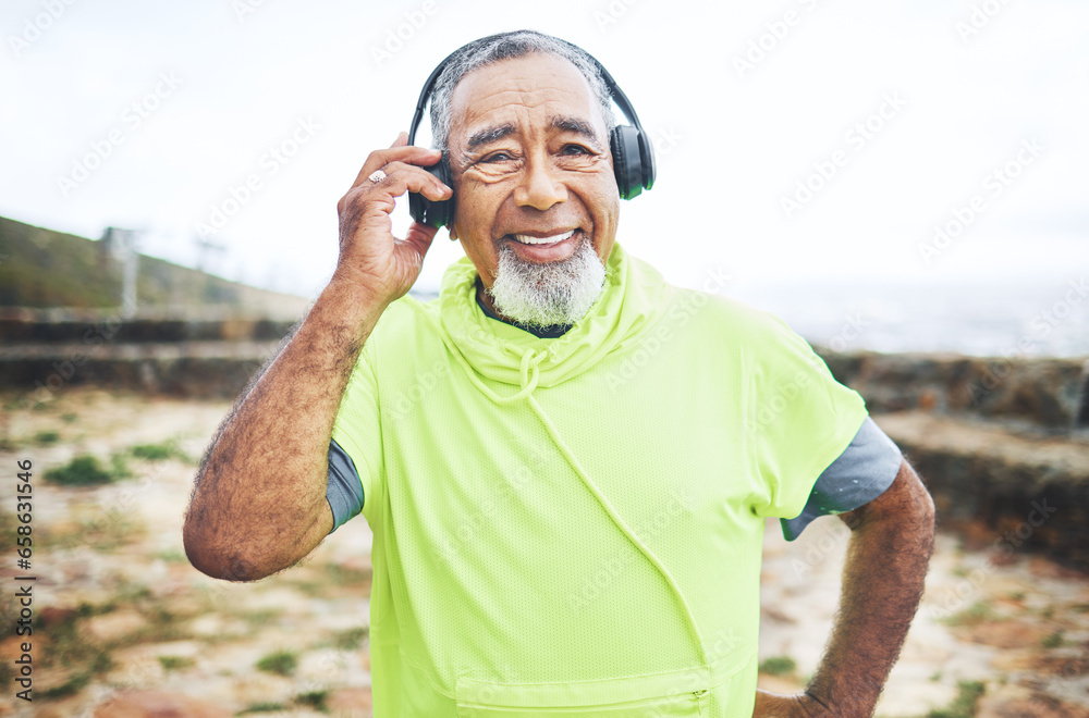 Happy, headphones and senior man hiking and listening to music, playlist or album for cardio workout. Smile, nature and portrait of elderly male person streaming a song for outdoor trekking in woods.