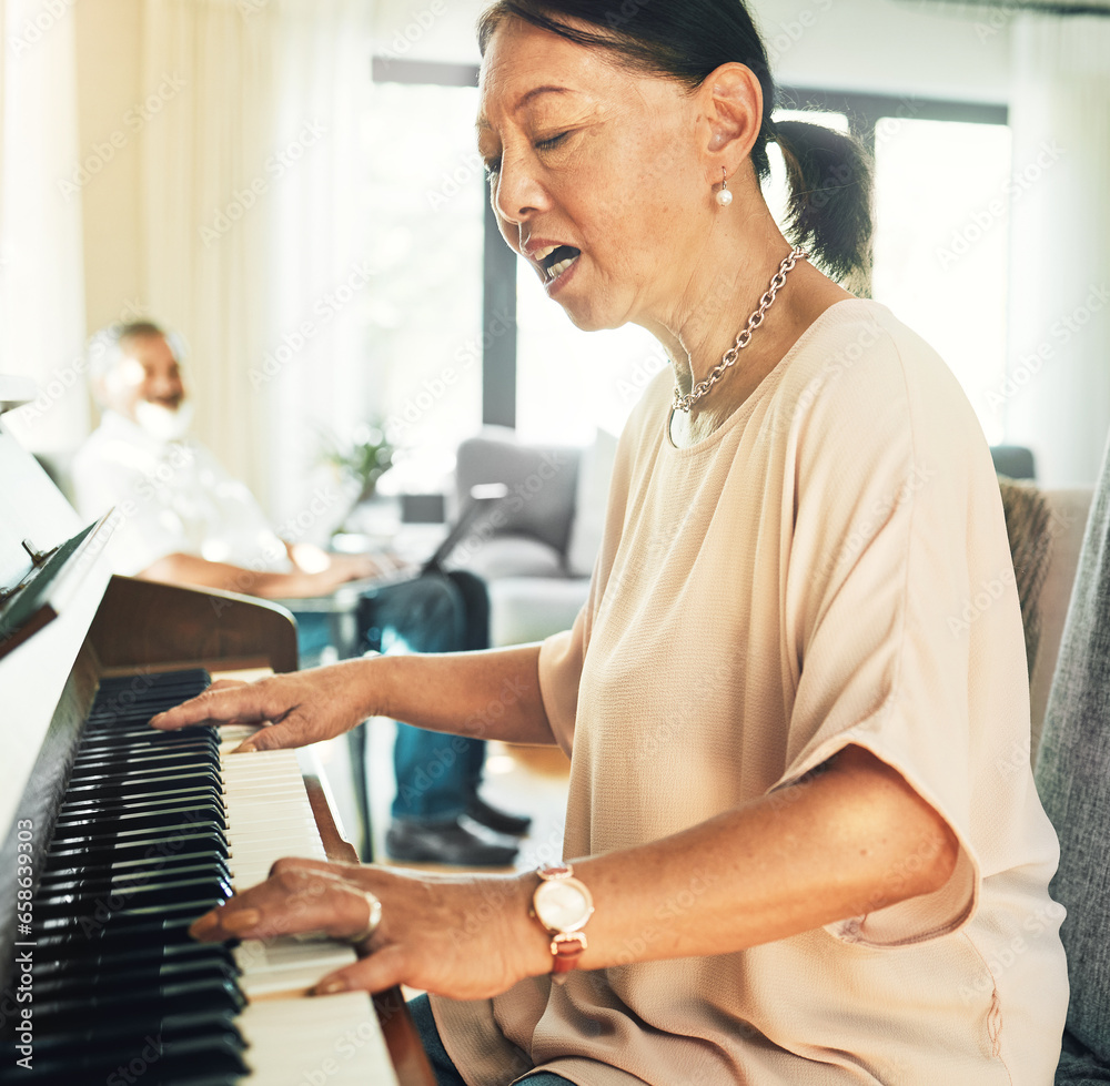 Singing, piano and senior woman playing for music with husband in living room for bonding and entertainment. Instrument, practice and elderly Asian man and woman in retirement with keyboard at home.