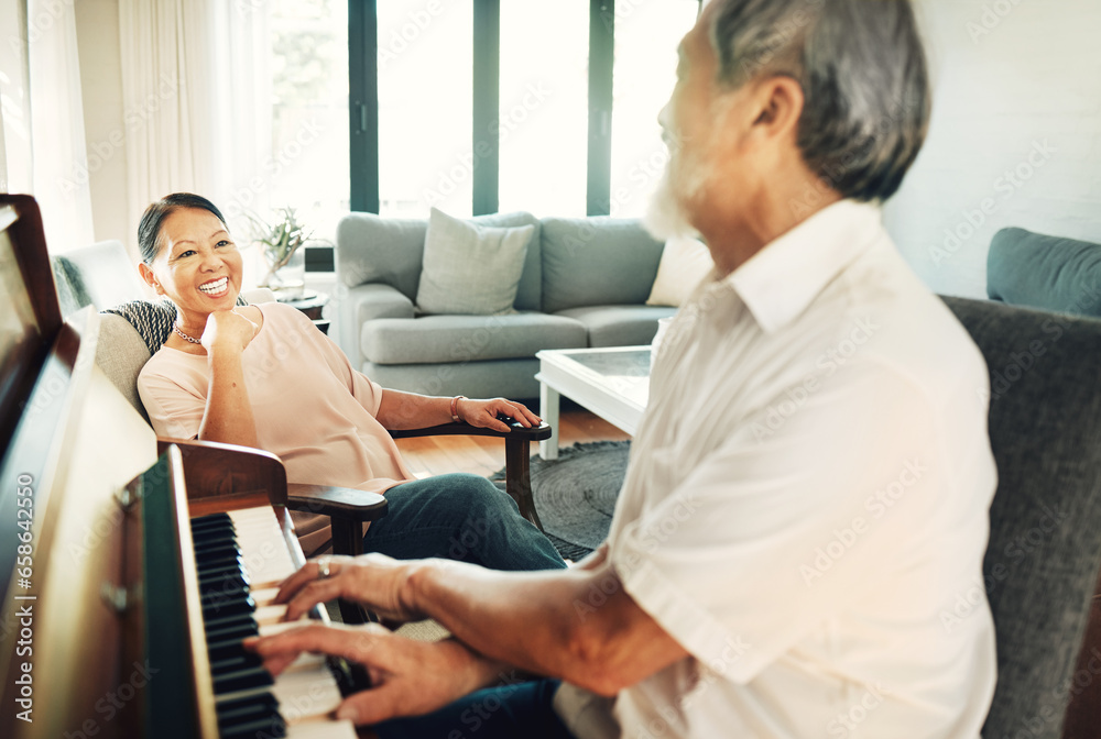 Happy, piano and senior man playing for music in living room with wife for bonding, entertainment or having fun. Instrument, smile and elderly Asian couple in retirement enjoy keyboard at modern home