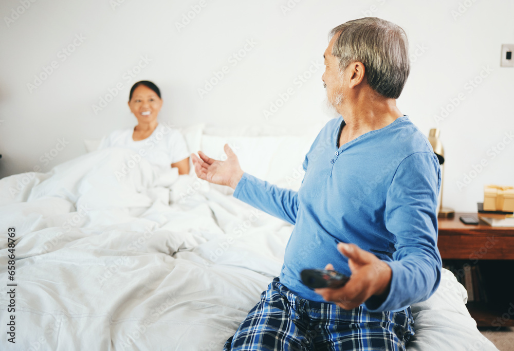 Happy senior couple, watching tv and bed for weekend, retirement or relax together at home. Man and woman with remote for online streaming, entertainment or enjoying holiday honeymoon in bedroom