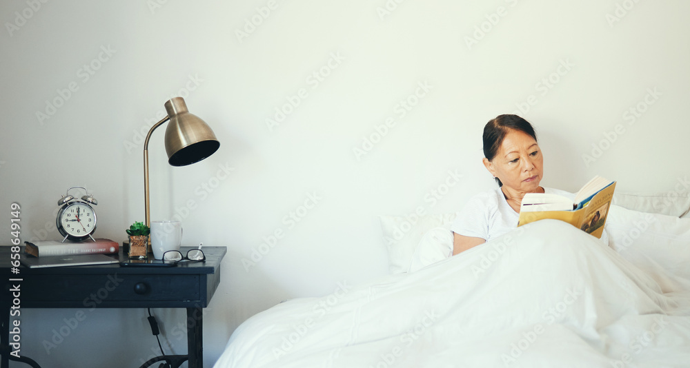 Bedroom, relax and senior woman reading a book, education and literature with peace, calm and resting. Bed, home and mature lady with fantasy, novel and thinking with elderly person and pensioner