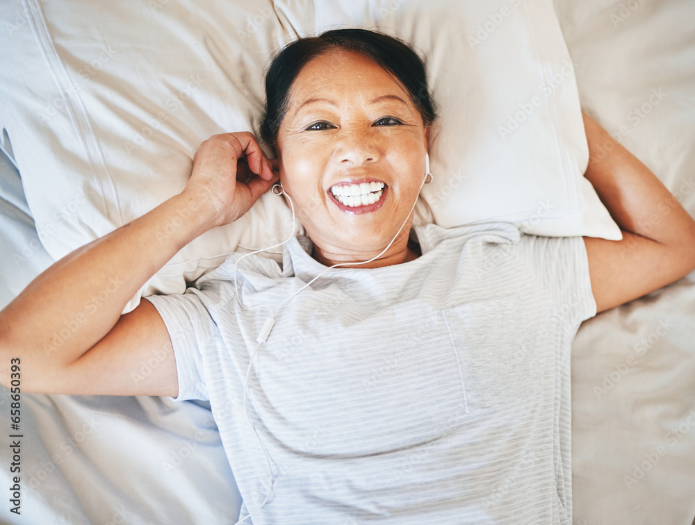 Bedroom face, music and relax happy woman sleeping, tired or nap for break, morning wellness or streaming audio podcast. Happiness, radio sound and top view person smile, rest and comfort on home bed