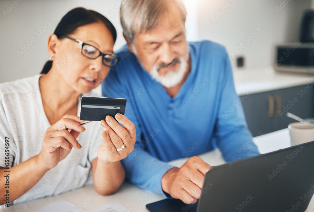 Mature couple, credit card and laptop for home online shopping, loan application or financial management in kitchen. Man and woman with computer for internet banking, security numbers or registration