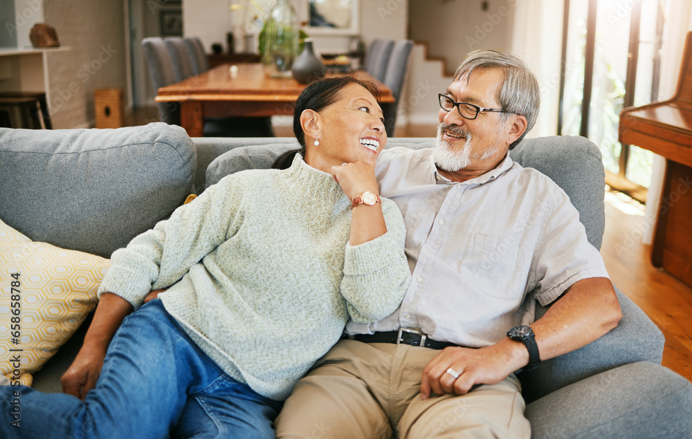 Smile, happy and senior couple on a sofa bonding, talking and relaxing together in living room. Romance, love and elderly man and woman in retirement in conversation by modern lounge at home.