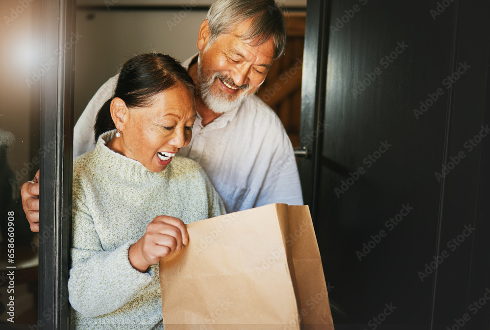 Couple, online shopping or package with smile for delivery, cargo or present at front door of home. Asian, senior man or woman with gift bag, ecommerce or surprise product in house or apartment