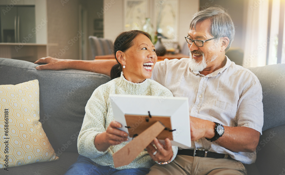 Picture frame, happy and senior couple on a sofa bonding, talking and relaxing together in living room. Smile, laugh and elderly man and woman in retirement looking at photo memory in lounge at home.