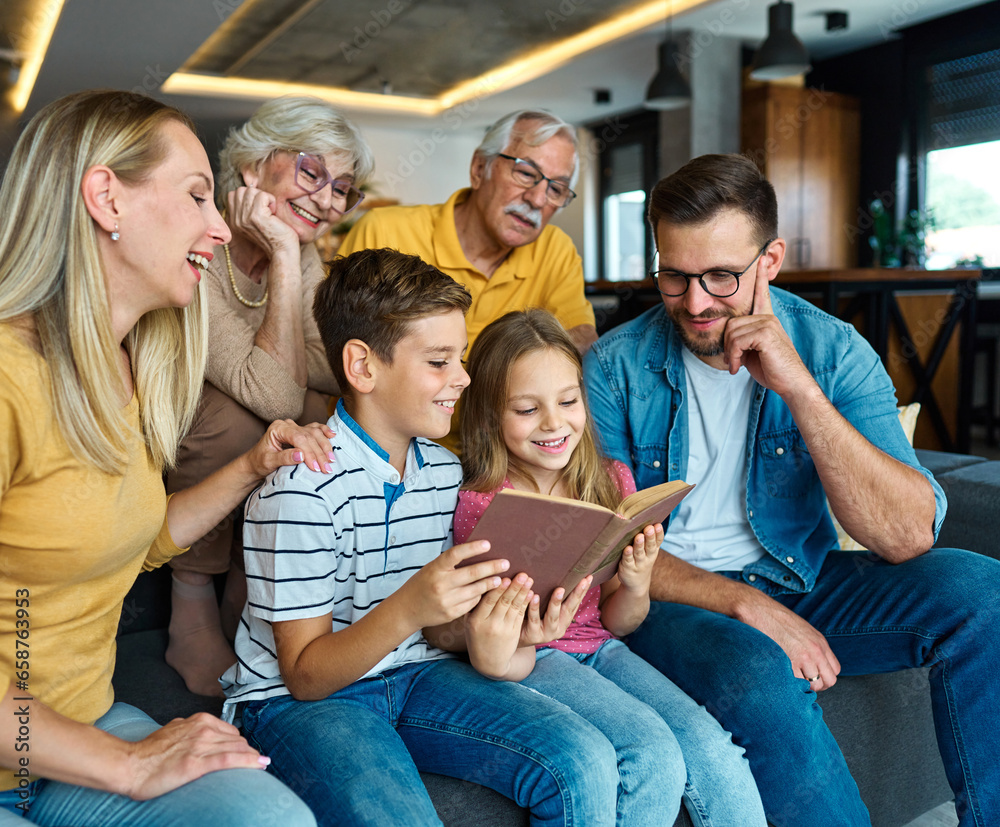 child family portrait woman mother man father grandmother daughter group reading book education girl grandparent generation female grandchild together senior grandfather son boy three