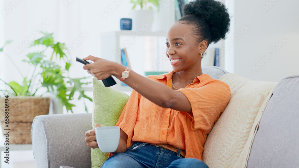 Woman, coffee and remote of tv on sofa at home to watch subscription, cable show and movies. Happy african person, drinking tea and relax in living room for television, multimedia broadcast and film