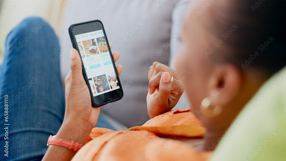 Hands, phone and food order with a black woman on a sofa to relax in the living room of her home. Mobile, screen or display with an online customer searching for a luxury product on a meal website