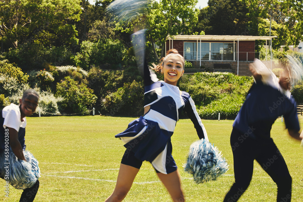 Cheerleader, people and teamwork with hand up in routine at university stadium, sport and uniform for game. Asian teen, diversity and team in collaboration with pom poms and fitness for competition