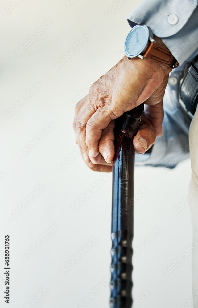 Elderly, person and hand with walking stick in closeup for assistance, walk or health in nursing home. Wrinkles, fingers and hold on blurred background for retirement, support or wellness in facility