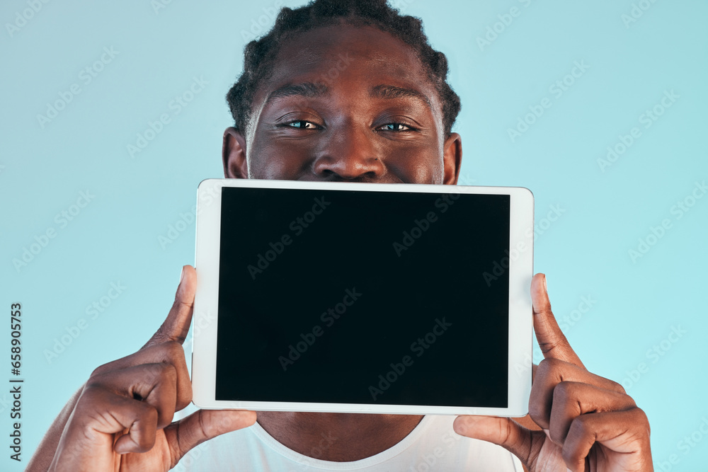 Tablet, screen and black man with mockup in studio with news, promo or announcement on blue background. Digital, offer and portrait of African male model show space for social media, sign up or deal