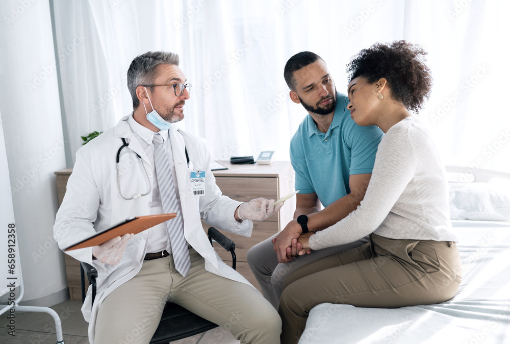 Hospital, doctor and couple with sad news for medical service, comfort and empathy for diagnosis. Healthcare, consulting and person with man and woman holding hands for support, wellness or results