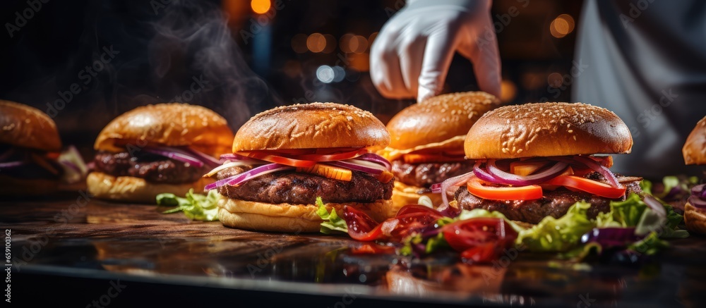 Chef crafting mouth watering burgers packed with bacon cheese and veggies