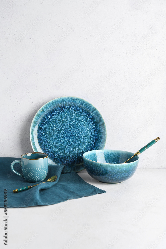 Set of clean blue dishes on white table