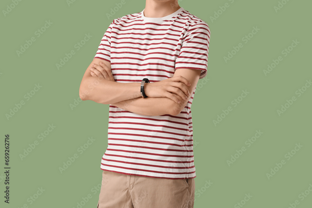 Man in stylish t-shirt on green background