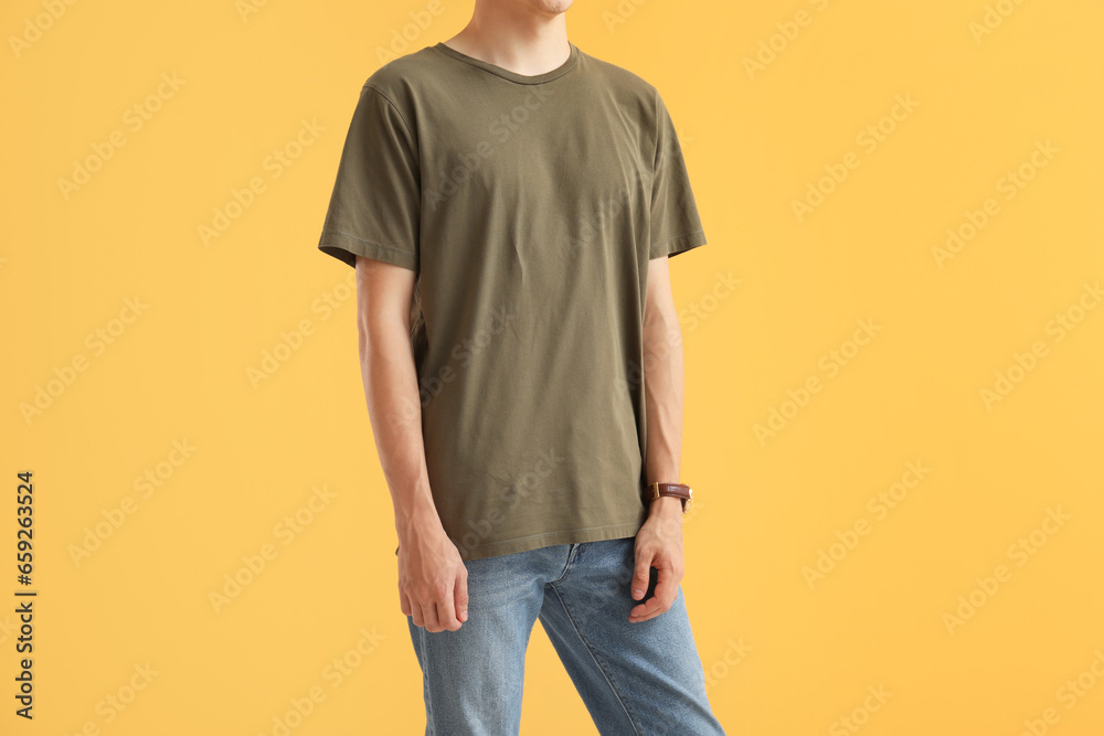 Man in stylish t-shirt on orange background