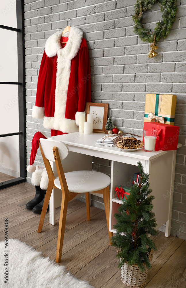 Interior of room decorated for Christmas with table and Santa costume