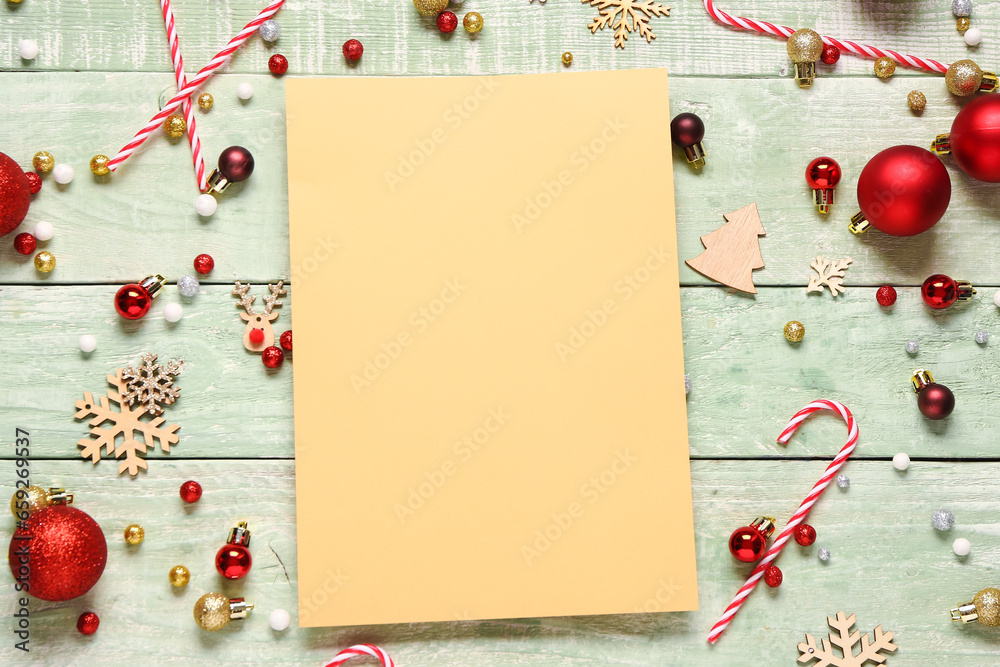 Beautiful composition with blank card and Christmas decorations on green wooden background