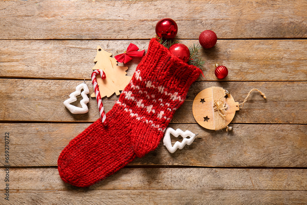 Christmas sock with beautiful decorations on wooden background