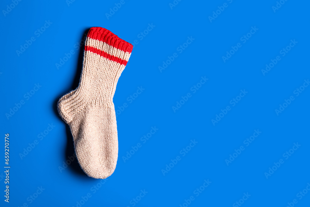 Christmas sock hanging on blue background