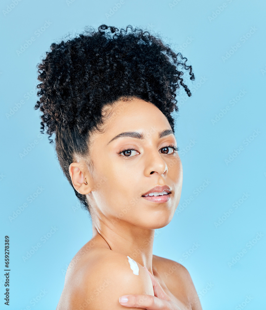 Beauty, studio portrait and woman with body cream application, dermatology product or lotion for skin hydration glow. Spa salon wellness, shoulder creme and aesthetic model shine on blue background