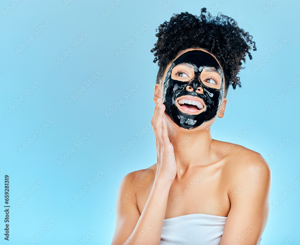 Skincare, happy and woman with charcoal face mask for facial treatment, anti aging and wellness in studio. Beauty, dermatology and happy person for health, cosmetics or grooming on blue background