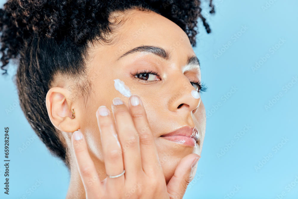 Beauty, studio portrait and woman with cream application of ointment, lotion or creme for skin hydration, wellness or skincare. Melasma treatment, face acne protection and model on blue background