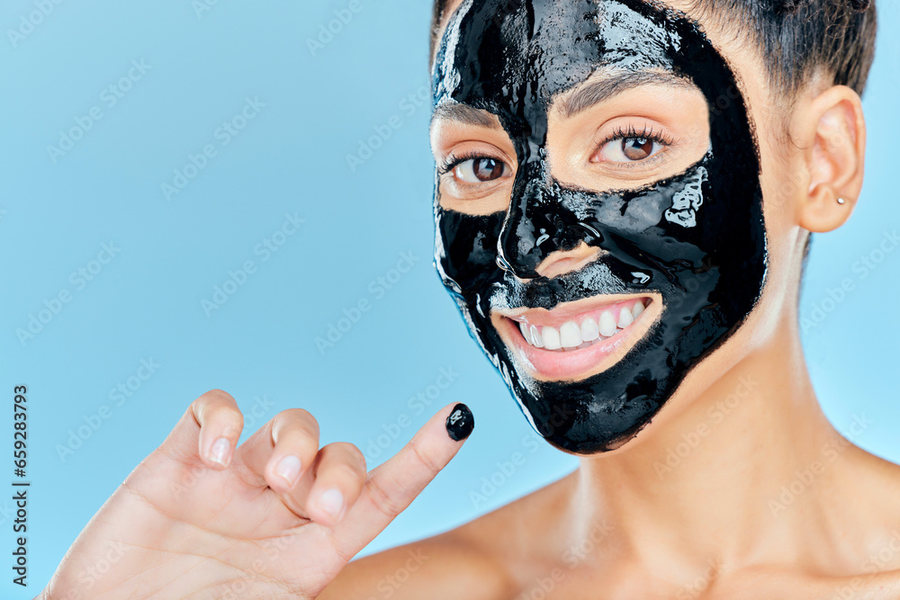 Beauty, charcoal face mask and portrait of woman for facial treatment, anti aging detox and wellness. Skincare, studio and person with products for health, cosmetics or grooming on blue background