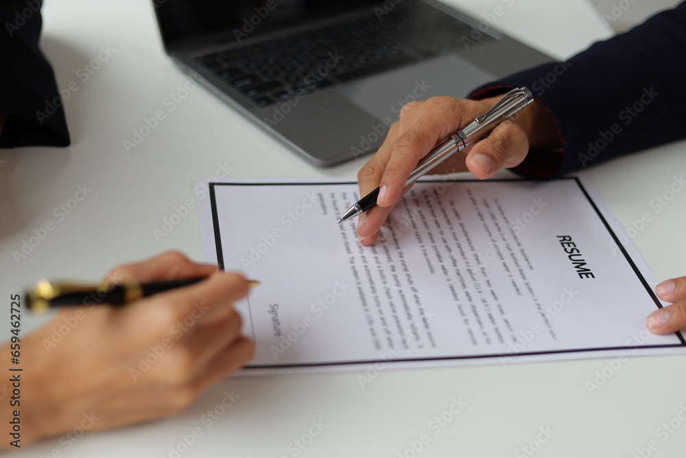 Manager reading resume while interviewing new employee candidates in office, job interview.