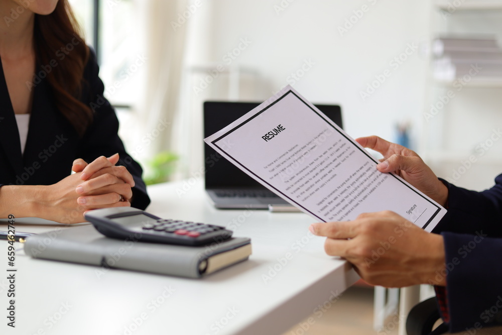 Manager reading resume while interviewing new employee candidates in office, job interview.