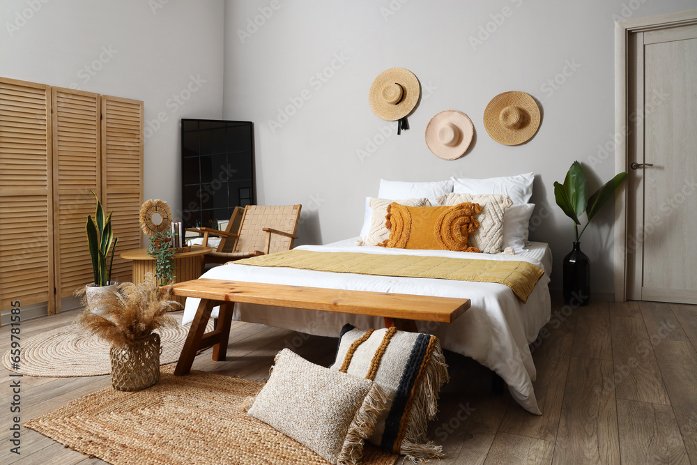 Interior of bedroom with coffee table, bed and bench