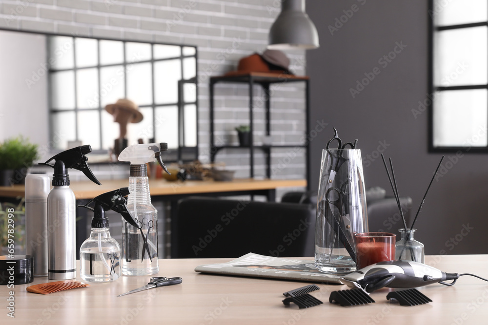 Different hairdressing tools on table in beauty salon