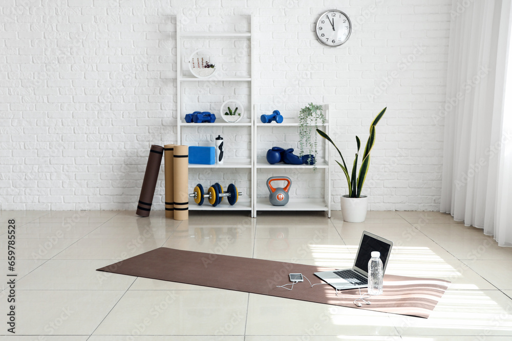 Interior of gym with shelving unit and sports equipment