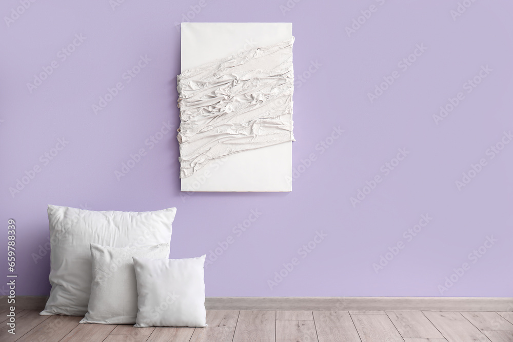 White pillows and painting near lilac wall