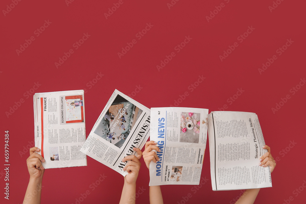 Female hands with different newspapers against color background