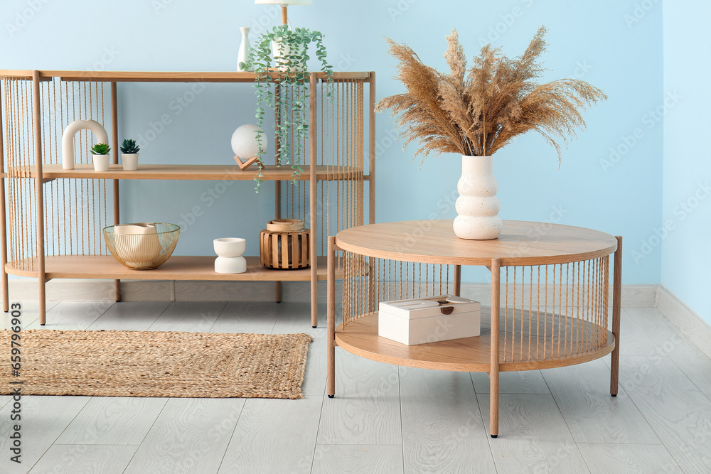 Vase with pampas grass on wooden coffee table in living room