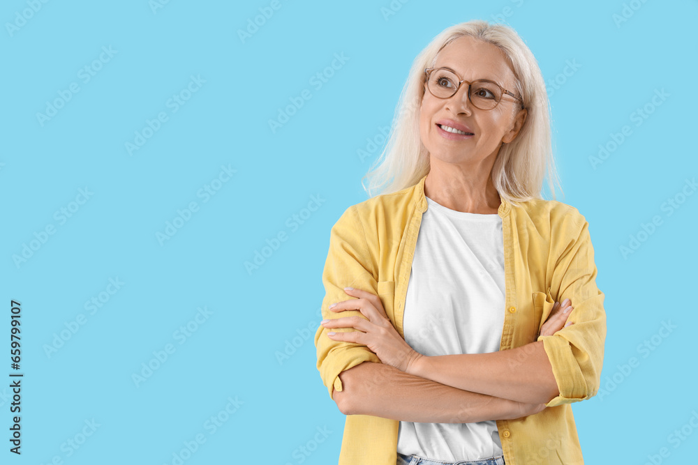 Dreaming mature woman on blue background