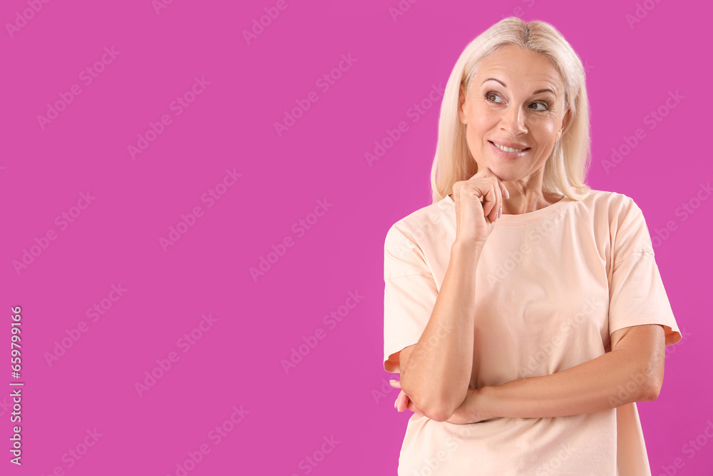 Dreaming mature woman on purple background