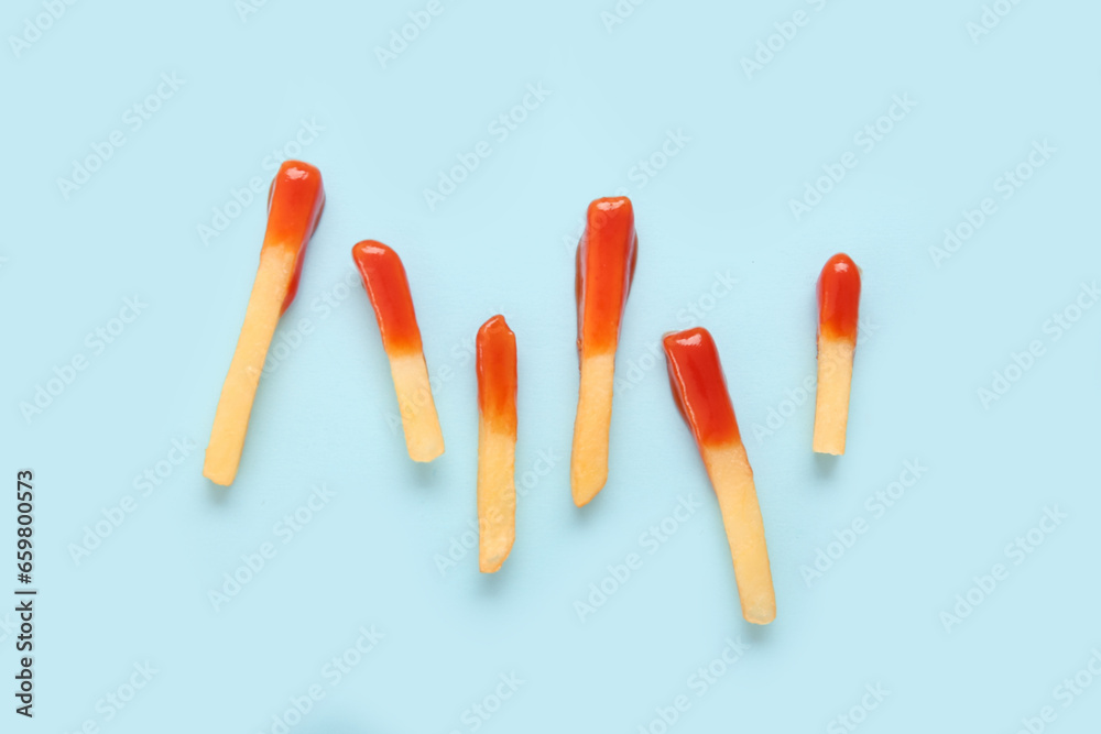 Tasty french fries with ketchup on blue background