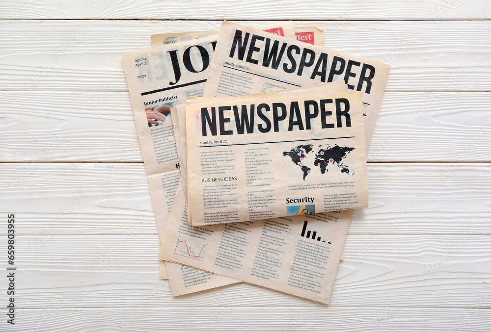 Morning newspapers on white wooden background