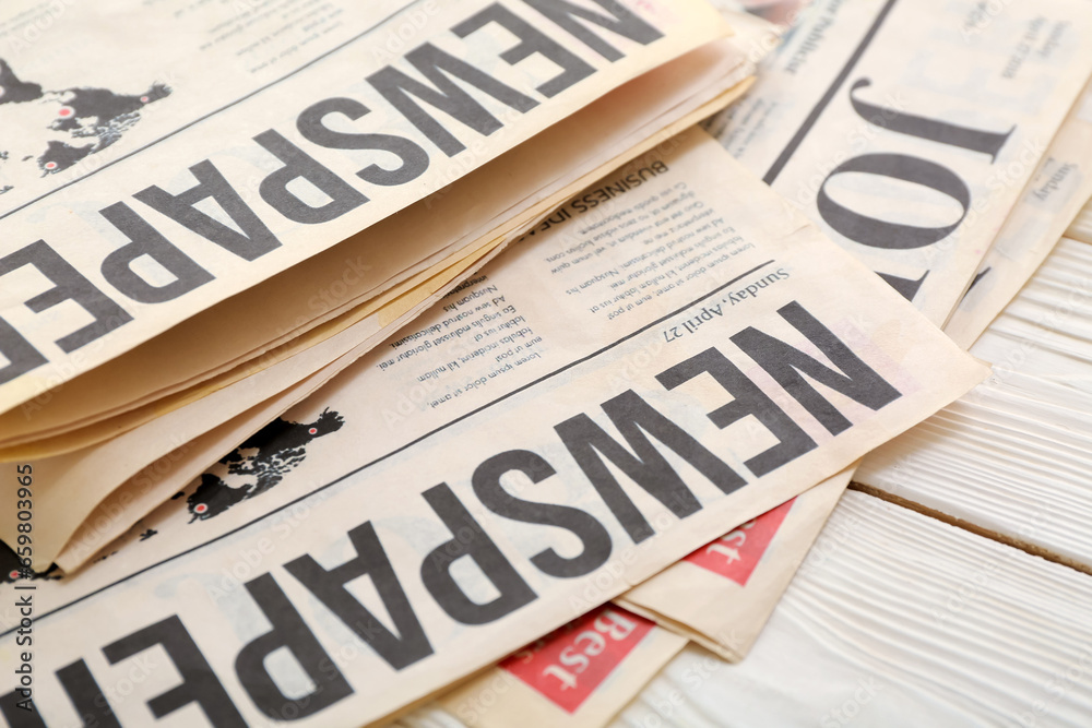 Morning newspapers on white wooden background