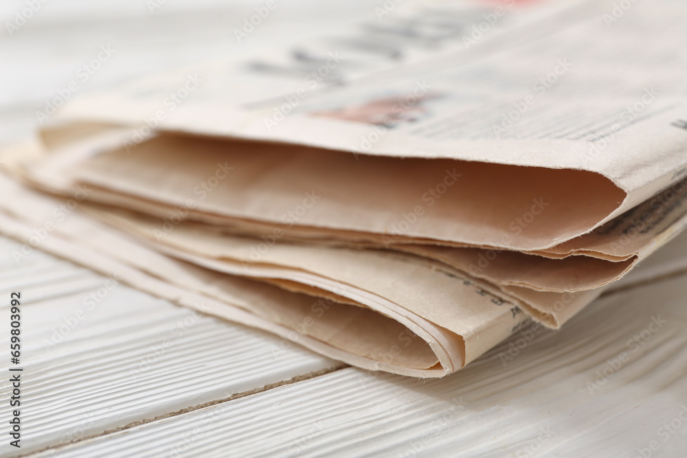 Morning newspapers on white wooden background