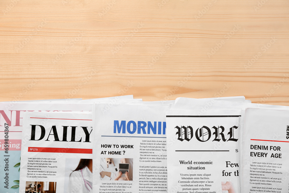 Morning newspapers on wooden background