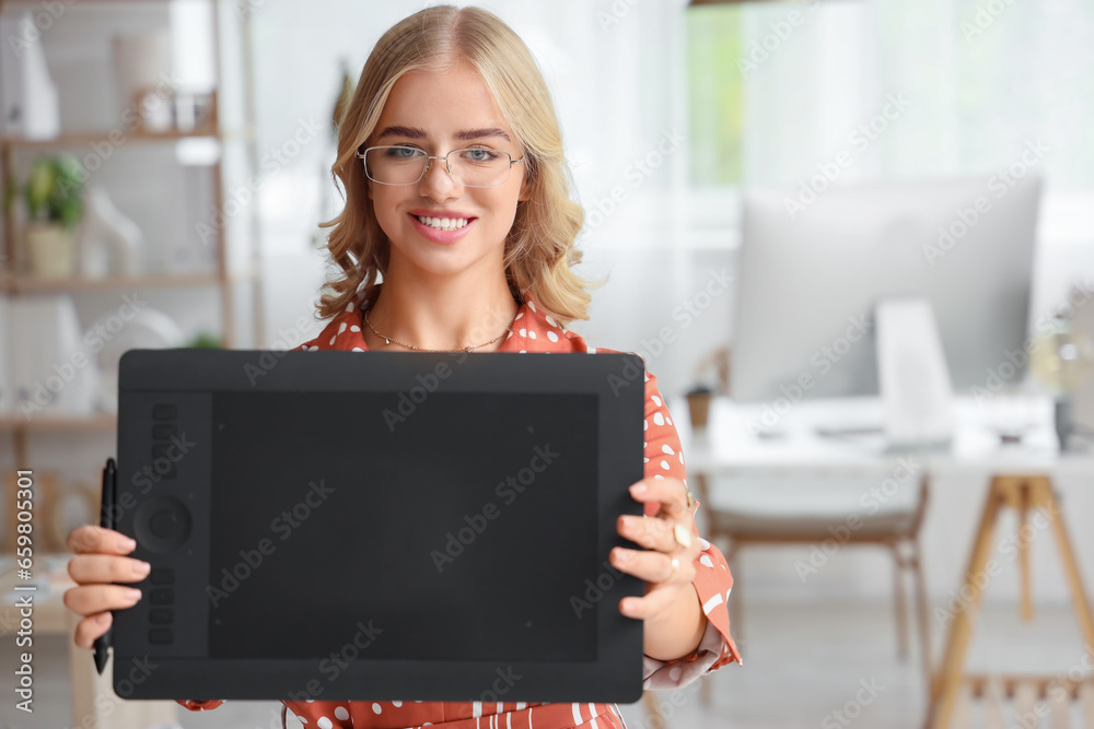 Female interior designer with graphic tablet in office