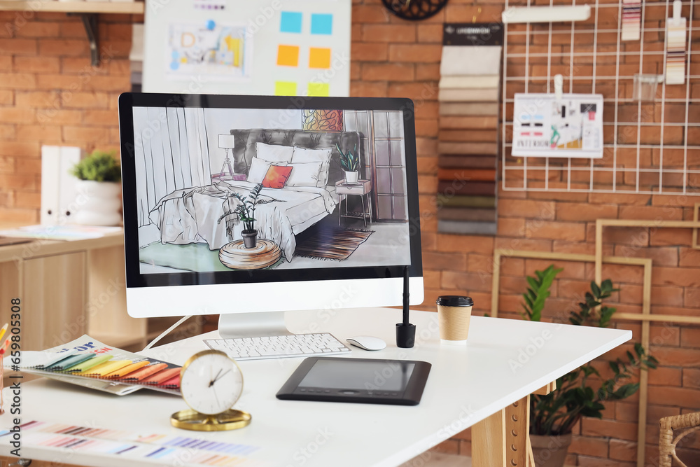 Interior designers workplace with computer monitor and graphic tablet in office