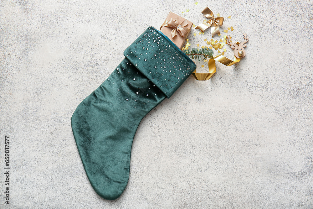 Beautiful Christmas sock with gift box and decorations on white background